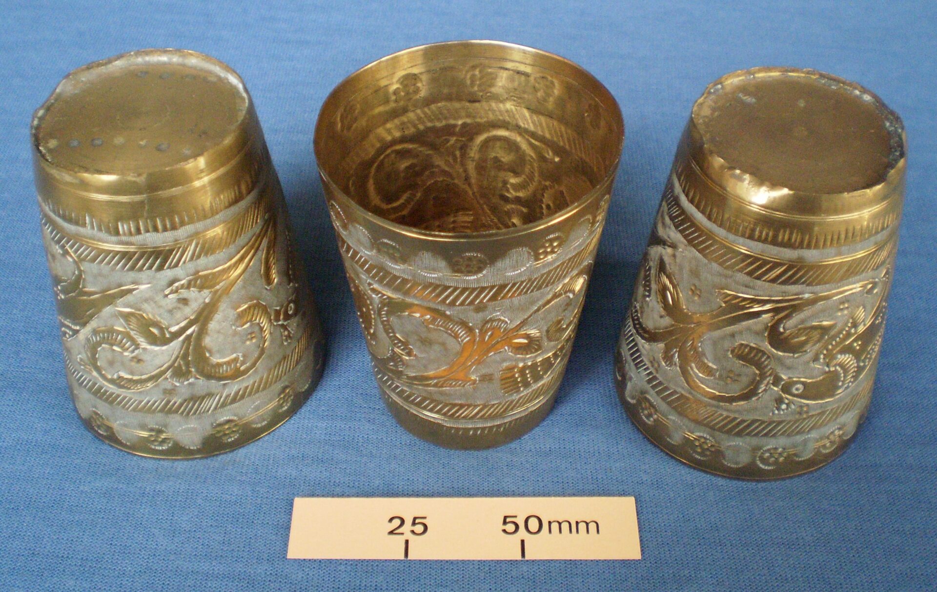 Set of three brass cups with box