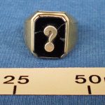 Gold ring with black stone & question mark