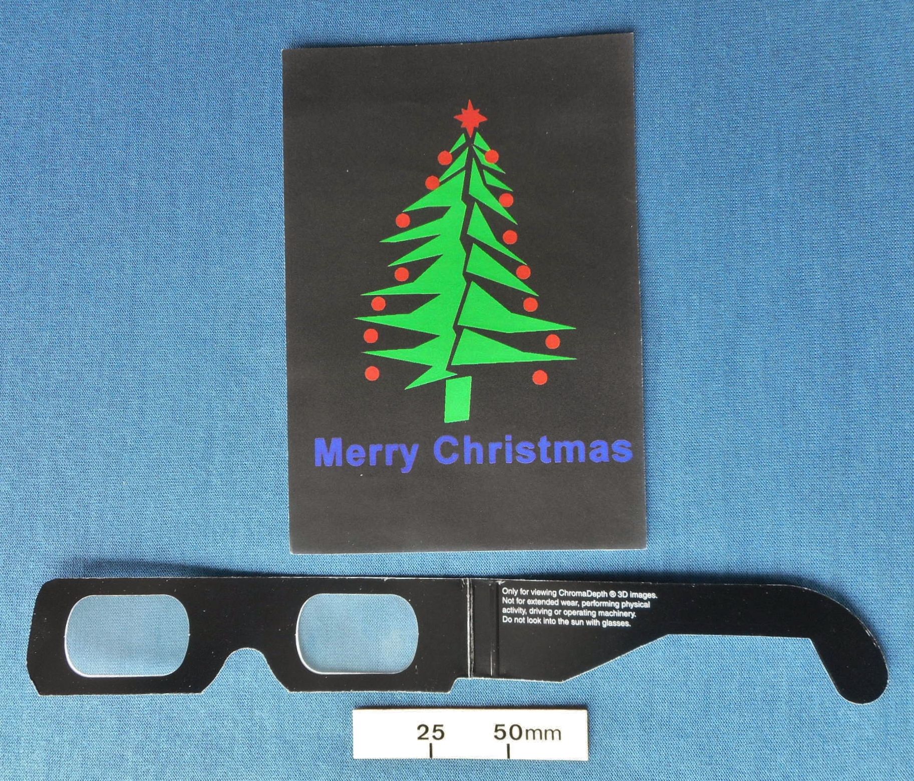 ChromaDepth (TM) glasses for a 3D effect with a Christmas tree card
