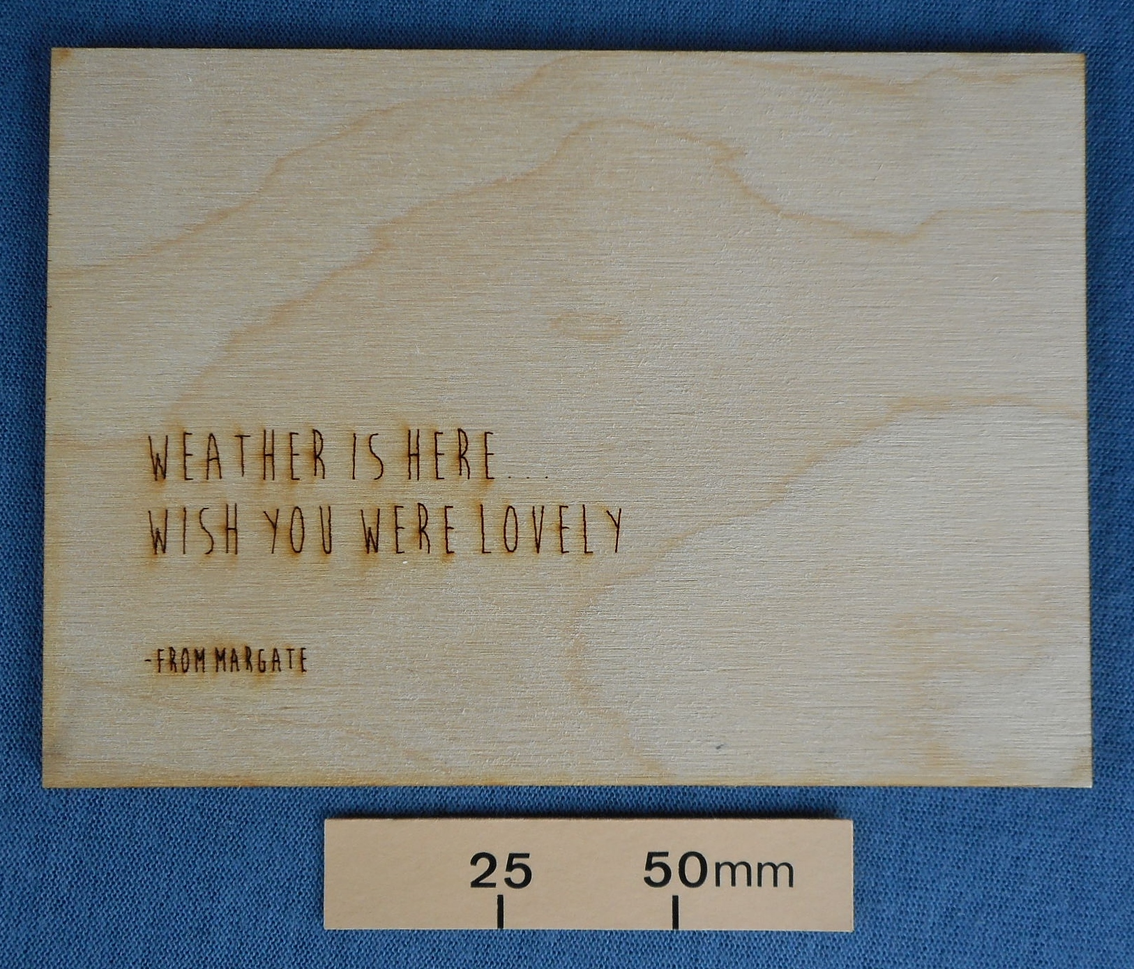 Novelty wooden postcard with a joke on one side