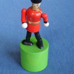 Wooden soldier collapsing thumb toy
