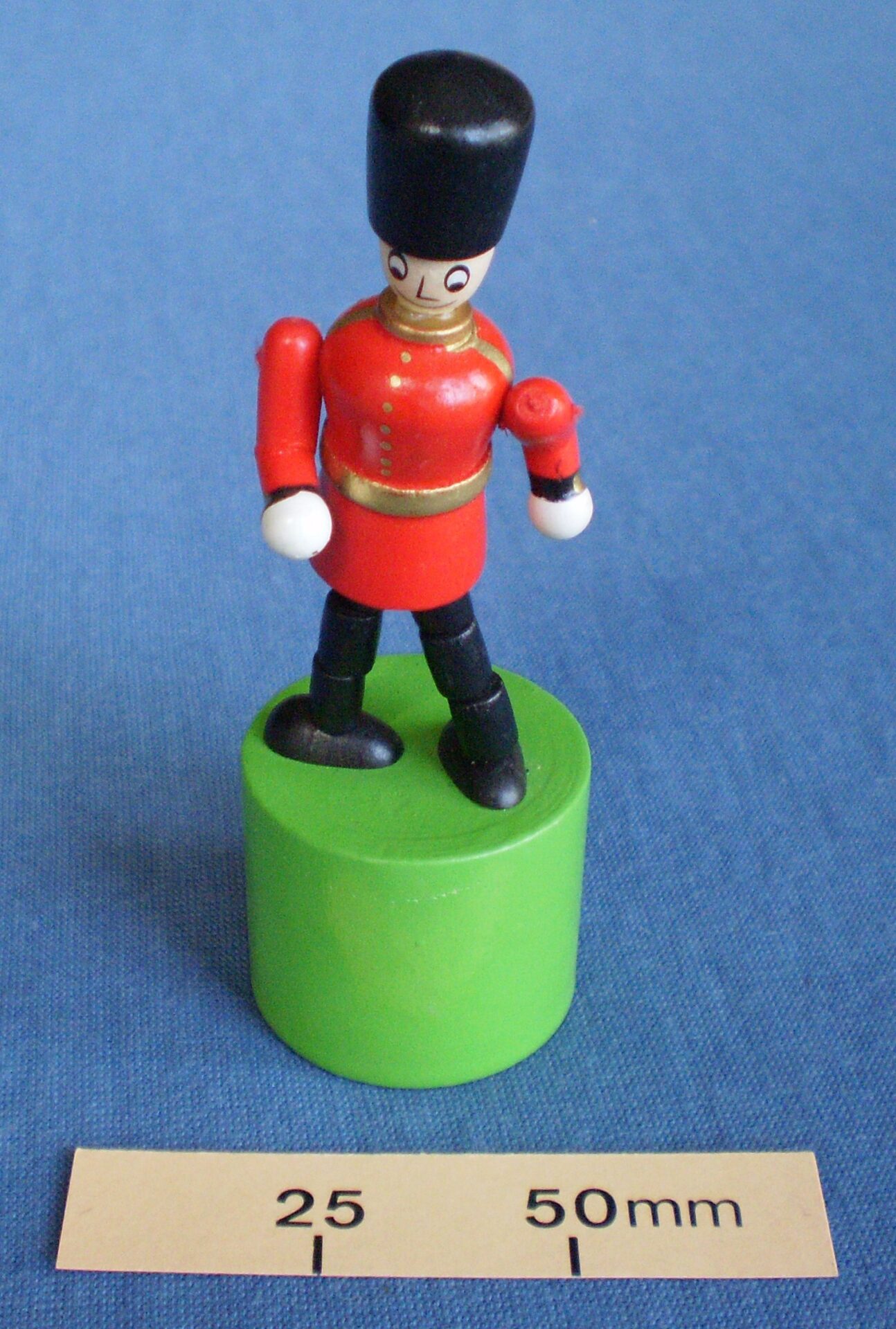 Wooden soldier collapsing thumb toy
