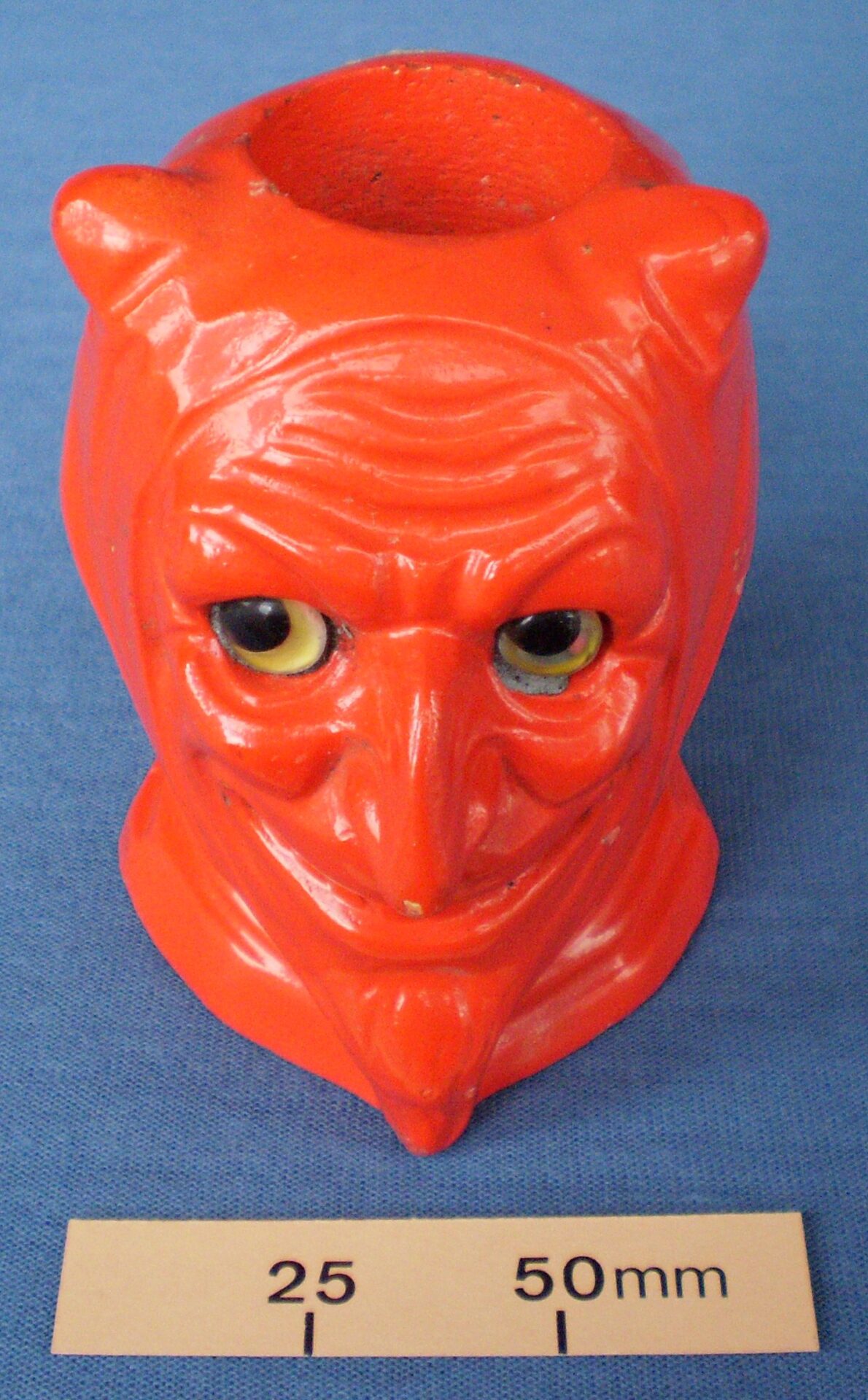 Red demon head match holder with striker on the back of the head