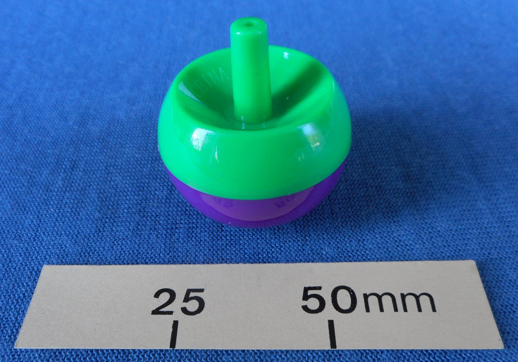 Green and purple Tippee Top found in a Christmas cracker