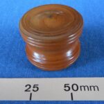 Turned wooden box probably used for a coin trick