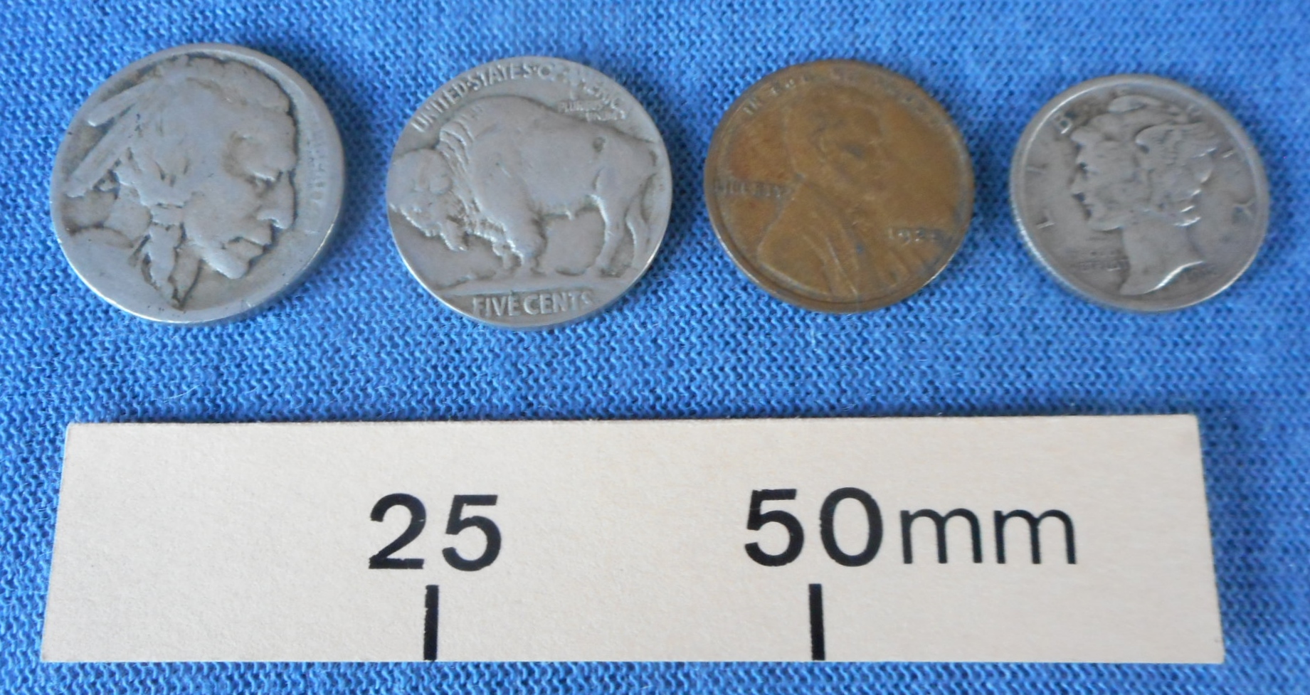 Set of four American coins for use in coin tricks